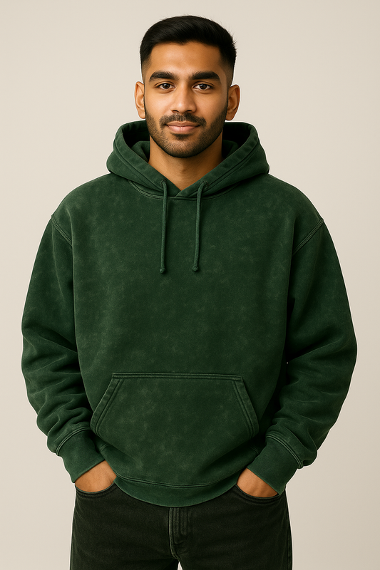 Man wearing a green hoodie against a beige background
